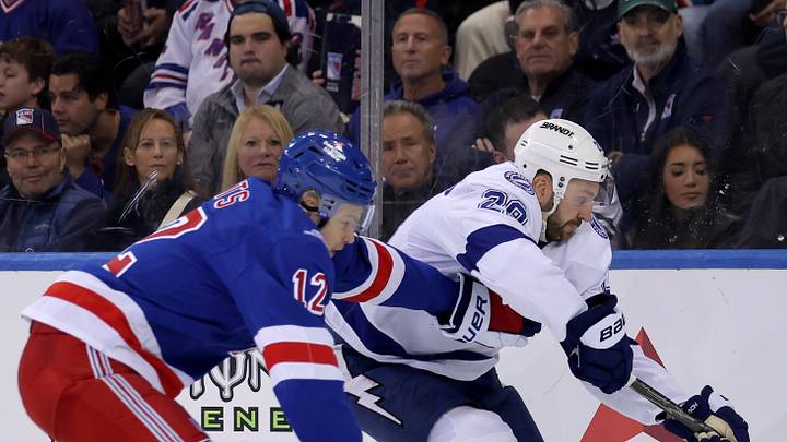 Oct 13, 2026; New York, New York, USA; Tampa Bay Lightning center Zemgus Girgensons (28) plays the puck against New York Rangers defenseman Alberts Smits (12) during the second period at Madison Square Garden. Mandatory Credit: Brad Penner-Imagn Images