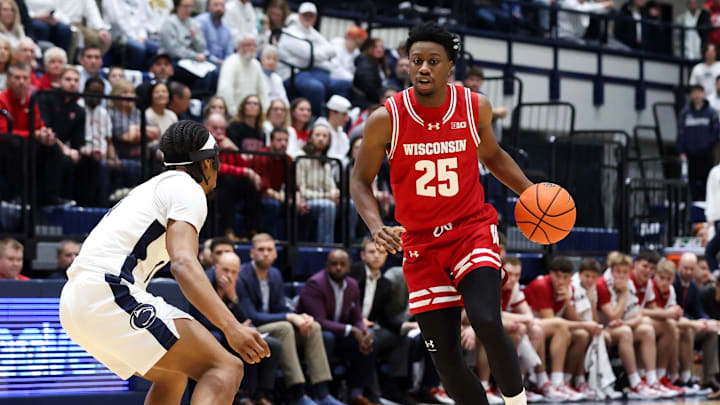 Jan 22, 2026; University Park, Pennsylvania, USA; Wisconsin Badgers guard John Blackwell (25) dribbles against Penn State Nittany Lions guard Kayden Mingo (4) during the first half at Rec Hall. Mandatory Credit: Matthew O'Haren-Imagn Images