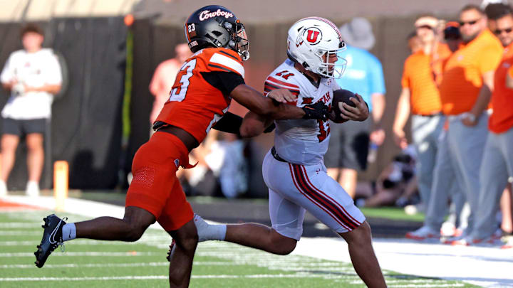 Oklahoma State's Kenneth Harris (23) pushes Utah's Isaac Wilson (11) out of bounds in the second half of the college football between the Oklahoma State University Cowboys and the Utah Utes at Boone Pickens Stadium in Stillwater, Okla., Saturday, Sept., 21, 2024.