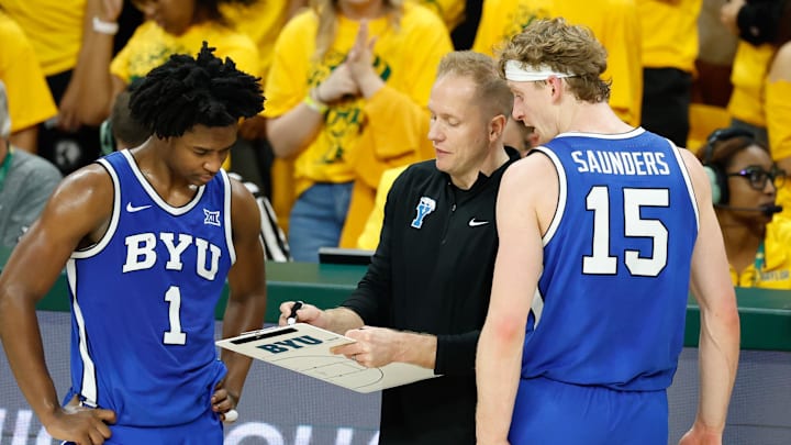 Feb 10, 2026; Waco, Texas, USA; BYU Cougars head coach Kevin Young speaks with BYU Cougars guard Robert Wright III (1) and guard Richie Saunders (15) during a break in play during the second half against the Baylor Bears at Paul and Alejandra Foster Pavilion. Mandatory Credit: Chris Jones-Imagn Images Feb 10, 2026; Waco, Texas, USA; BYU Cougars head coach Kevin Young speaks with BYU Cougars guard Robert Wright III (1) and guard Richie Saunders (15) during a break in play during the second half against the Baylor Bears at Paul and Alejandra Foster Pavilion. Mandatory Credit: Chris Jones-Imagn Images