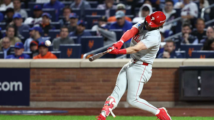Oct 9, 2024; New York, New York, USA; Philadelphia Phillies first baseman Bryce Harper (3) hits a double in the sixth inning against the New York Mets in game four of the NLDS for the 2024 MLB Playoffs at Citi Field. Mandatory Credit: Wendell Cruz-Imagn Images