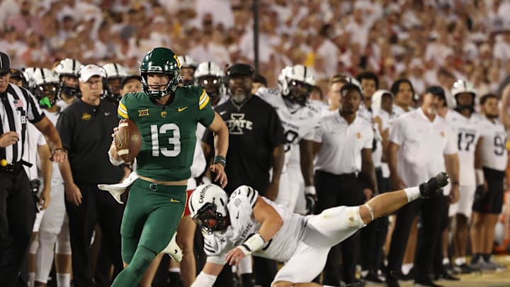 Oct 5, 2024; Ames, Iowa, USA; Baylor Bears quarterback Sawyer Robertson (13) runs for a first down against the Iowa State Cyclones at Jack Trice Stadium. The Cyclones beat the Bears 43 to 21.  Mandatory Credit: Reese Strickland-Imagn Images