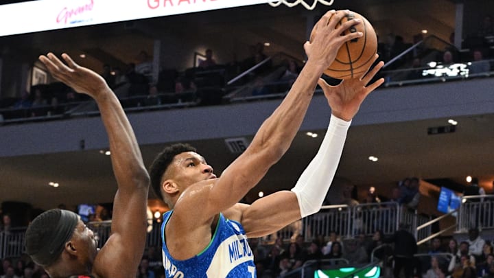 Feb 13, 2024; Milwaukee, Wisconsin, USA;  Milwaukee Bucks forward Giannis Antetokounmpo (34) drives to the basket against Miami Heat center Bam Adebayo (13) in the first half at Fiserv Forum. Mandatory Credit: Michael McLoone-Imagn Images