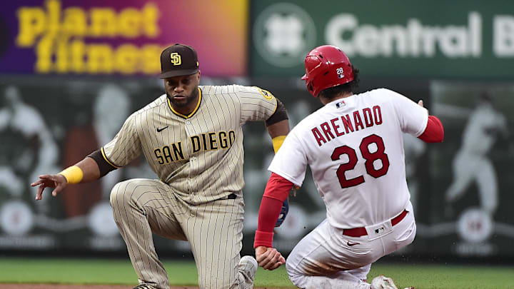 May 31, 2022; St. Louis, Missouri, USA;  San Diego Padres second baseman Robinson Cano (24) tags out St. Louis Cardinals third baseman Nolan Arenado (28) on a stolen base attempt during the third inning at Busch Stadium. Mandatory Credit: Jeff Curry-Imagn Images