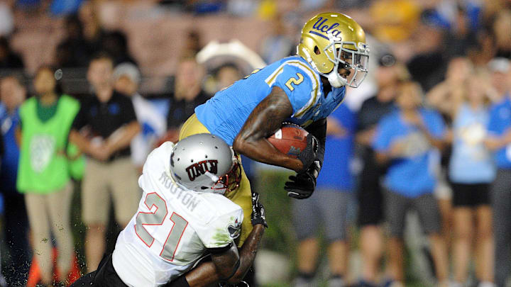 September 10, 2016; Pasadena, CA, USA;  UCLA Bruins wide receiver Jordan Lasley (2) runs the ball for a first down against the  defense of UNLV Rebels defensive back Darius Mouton (21) during the second half at Rose Bowl. Mandatory Credit: Gary A. Vasquez-Imagn Images