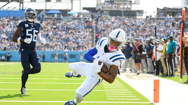 Oct 13, 2024; Nashville, Tennessee, USA;  Indianapolis Colts wide receiver Josh Downs (1) makes a touchdown catch over Tennessee Titans linebacker Kenneth Murray Jr. (56) during the first half at Nissan Stadium. Mandatory Credit: Steve Roberts-Imagn Images