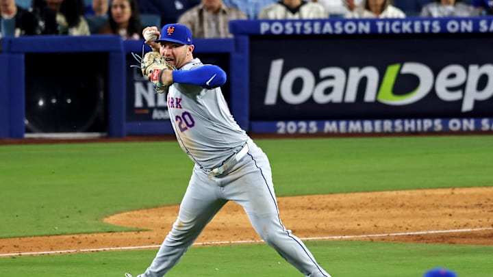 Oct 20, 2024; Los Angeles, California, USA; New York Mets first base Pete Alonso (20) throws late to second base allowing the runner to reach second base during the sixth inning during game six of the NLCS for the 2024 MLB playoffs at Dodger Stadium. Mandatory Credit: Jason Parkhurst-Imagn Images