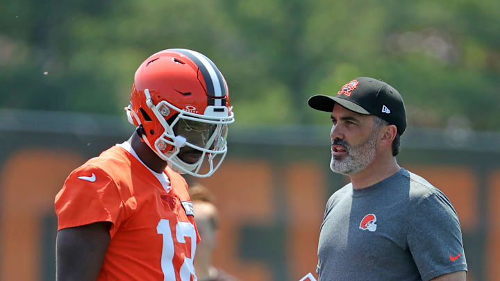 Cleveland Browns quarterback Shedeur Sanders (12) speaks with head coach Kevin Stefanski during practice at NFL minicamp, Wednesday, June 11, 2025, in Berea, Ohio.