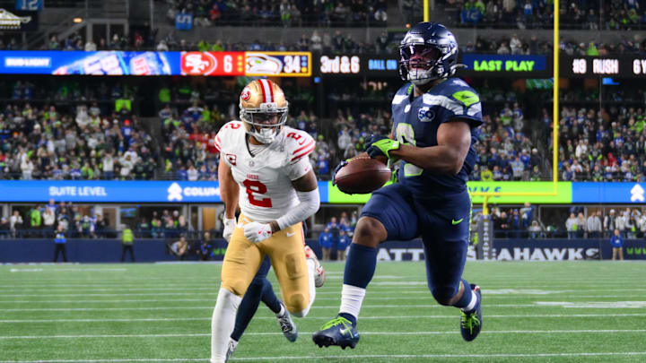 Jan 17, 2026; Seattle, WA, USA; Seattle Seahawks running back Kenneth Walker III (9) carries the ball for a touchdown as San Francisco 49ers cornerback Deommodore Lenoir (2) trails on the play during the second half in an NFC Divisional Round game at Lumen Field. Mandatory Credit: Steven Bisig-Imagn Images