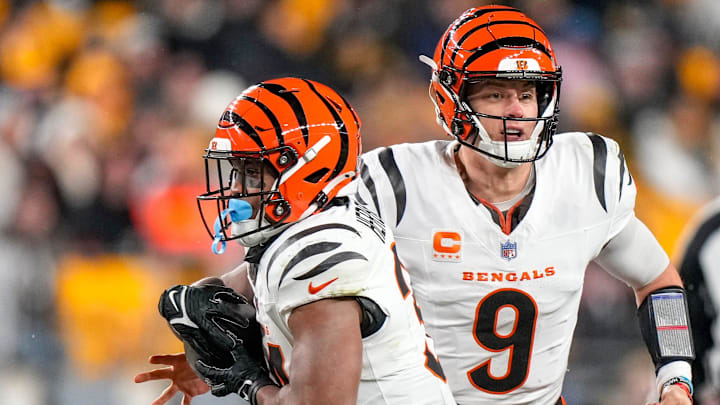 Cincinnati Bengals quarterback Joe Burrow (9) hands off to running back Khalil Herbert (34) in the second quarter against the Pittsburgh Steelers at Acrisure Stadium.