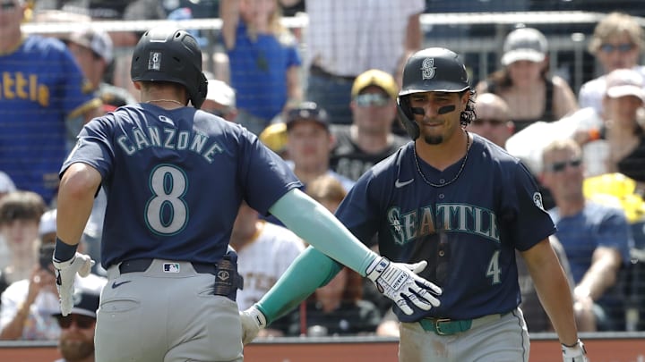Seattle Mariners third baseman Josh Rojas (4) greets right fielder Dominic Canzone (8) crossing home plate on a solo home run against the Pittsburgh Pirates during the fifth inning at PNC Park in 2024. Seattle Mariners third baseman Josh Rojas (4) greets right fielder Dominic Canzone (8) crossing home plate on a solo home run against the Pittsburgh Pirates during the fifth inning at PNC Park in 2024.