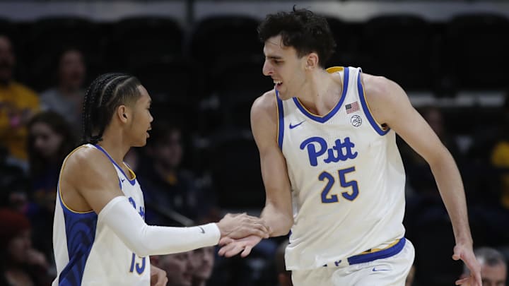 Dec 21, 2024; Pittsburgh, Pennsylvania, USA; Pittsburgh Panthers guard Jaland Lowe (left) congratulates forward Guillermo Diaz Graham (25) on his three point basket against the Sam Houston State Bearkats during the first half at the Petersen Events Center. Mandatory Credit: Charles LeClaire-Imagn Images