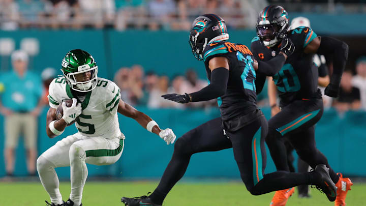 Sep 29, 2025; Miami Gardens, Florida, USA; New York Jets wide receiver Garrett Wilson (5) makes a catch against Miami Dolphins free safety Minkah Fitzpatrick (29) during the first half at Hard Rock Stadium. Mandatory Credit: Sam Navarro-Imagn Images