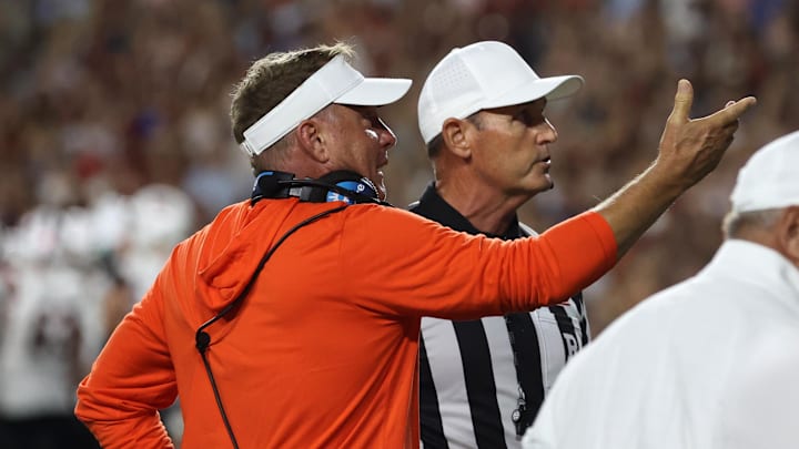 Sep 6, 2025; Auburn, Alabama, USA;  Auburn Tigers head coach Hugh Freeze complains to a game official as they look at the Jumbotron during the third quarter against the Ball State Cardinals at Jordan-Hare Stadium. Mandatory Credit: John Reed-Imagn Images