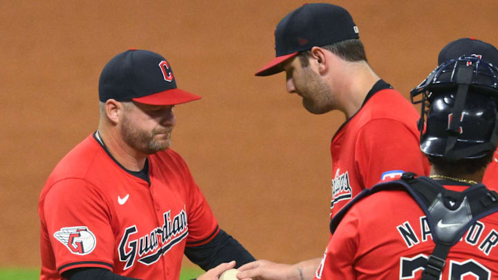 Sep 12, 2024; Cleveland, Ohio, USA; Cleveland Guardians manager Stephen Vogt (12) takes the ball from starting pitcher Gavin Williams (32) during a pitching change in the sixth inning against the Tampa Bay Rays at Progressive Field. Mandatory Credit: David Richard-Imagn Images