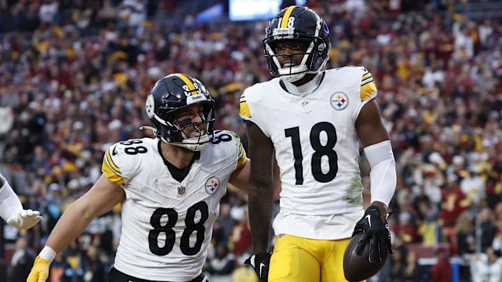 Nov 10, 2024; Landover, Maryland, USA; Pittsburgh Steelers wide receiver Mike Williams (18) celebrates with Steelers tight end Pat Freiermuth (88) after catching a touchdown pass against the Washington Commanders late in the second half at Northwest Stadium. Mandatory Credit: Geoff Burke-Imagn Images