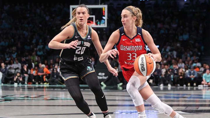 Sep 9, 2025; Brooklyn, New York, USA;  Washington Mystics guard Lucy Olsen (33) looks to drive past New York Liberty guard Sabrina Ionescu (20) in the first quarter at Barclays Center. Mandatory Credit: Wendell Cruz-Imagn Images