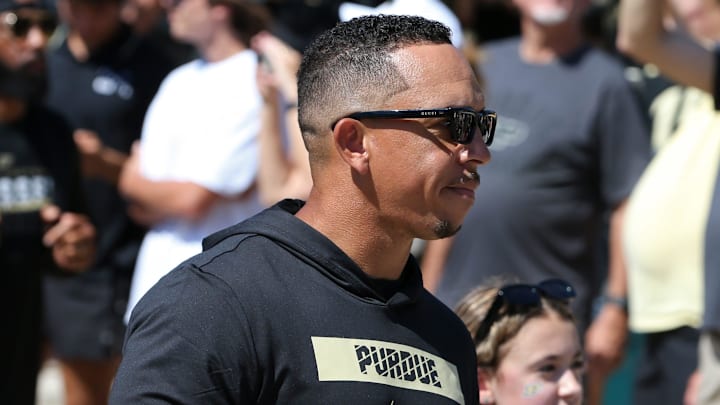 Purdue head coach Ryan Walters leads Purdue players as they arrive 