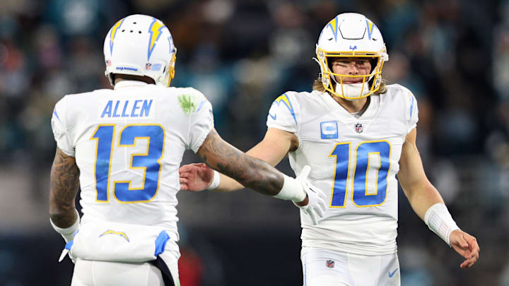 Jan 14, 2023; Jacksonville, Florida, USA; Los Angeles Chargers quarterback Justin Herbert (10) and wide receiver Keenan Allen (13) celebrate after a play during the second quarter a wild card game against the Jacksonville Jaguars at TIAA Bank Field. Mandatory Credit: Nathan Ray Seebeck-Imagn Images