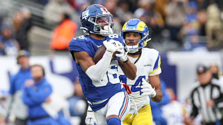 Dec 31, 2023; East Rutherford, New Jersey, USA; New York Giants wide receiver Darius Slayton (86) catches a touchdown pass during the second half as Los Angeles Rams cornerback Ahkello Witherspoon (44) defends at MetLife Stadium.