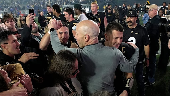 Vanderbilt coach Clark Lea shakes hands with fans as he hugs quarterback Diego Pavia (2) after the team’s win against Kentucky at FirstBank Stadium in Nashville, Tenn., Saturday, Nov. 22, 2025.