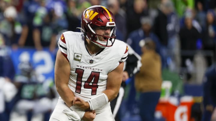 Nov 12, 2023; Seattle, Washington, USA; Washington Commanders quarterback Sam Howell (14) celebrates after throwing a touchdown pass against the Seattle Seahawks during the fourth quarter at Lumen Field. Mandatory Credit: Joe Nicholson-USA TODAY Sports