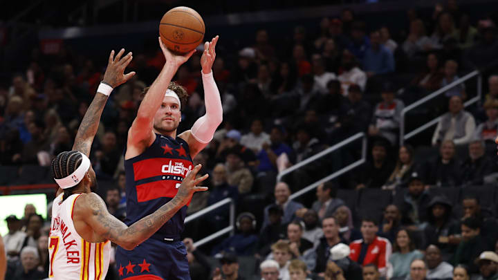 Nov 25, 2025; Washington, District of Columbia, USA; Washington Wizards forward Corey Kispert (24) shoots the ball as Atlanta Hawks guard Nickeil Alexander-Walker (7) defends in the second half at Capital One Arena. Mandatory Credit: Geoff Burke-Imagn Images