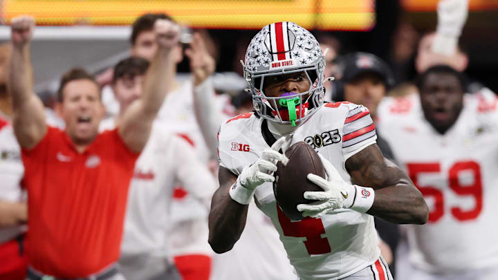 Jan 20, 2025; Atlanta, GA, USA; Ohio State Buckeyes wide receiver Jeremiah Smith (4) makes a catch against the Notre Dame Fighting Irish during the second half the CFP National Championship college football game at Mercedes-Benz Stadium. Mandatory Credit: Brett Davis-Imagn Images