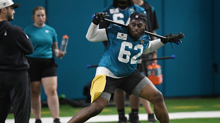 Jacksonville Jaguars offensive tackle Javon Foster (62) works out during Friday's rookie minicamp. The Jacksonville Jaguars held their first day of rookie minicamp inside the covered field at the Jaguars performance facility in Jacksonville, Florida Friday, May 10, 2024.