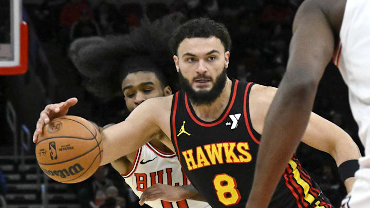 Jan 15, 2025; Chicago, Illinois, USA;  Chicago Bulls guard Coby White (0) tries to steal the ball from Atlanta Hawks forward David Roddy (8) during the second half at the United Center. Mandatory Credit: Matt Marton-Imagn Images