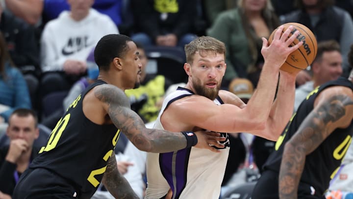 Oct 29, 2024; Salt Lake City, Utah, USA; Sacramento Kings forward Domantas Sabonis (11) spins toward the basket against Utah Jazz forward John Collins (20 during the third quarter at Delta Center. Mandatory Credit: Rob Gray-Imagn Images