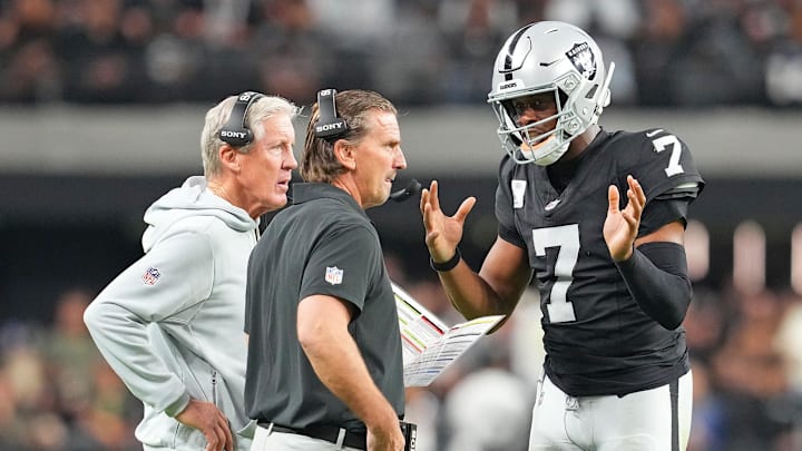 Nov 23, 2025; Paradise, Nevada, USA; Las Vegas Raiders quarterback Geno Smith (7) talks with head coach Pete Carroll and quarterbacks coach Greg Olsen in a game against the Cleveland Browns during the fourth quarter at Allegiant Stadium. Mandatory Credit: Stephen R. Sylvanie-Imagn Images