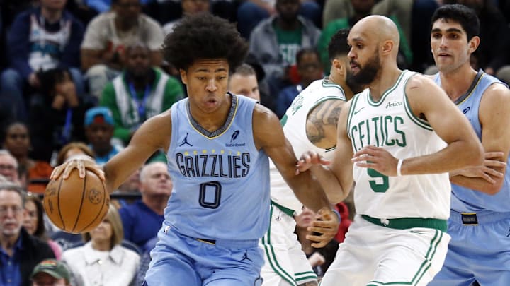 Mar 31, 2025; Memphis, Tennessee, USA; Memphis Grizzlies forward Jaylen Wells (0) dribbles as Boston Celtics guard Derrick White (9) defends during the second quarter at FedExForum. Mandatory Credit: Petre Thomas-Imagn Images