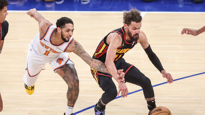 Feb 12, 2025; New York, New York, USA; New York Knicks guard Cameron Payne (1) and Atlanta Hawks guard Trae Young (11) fight for a loose ball in the fourth quarter at Madison Square Garden. Mandatory Credit: Wendell Cruz-Imagn Images