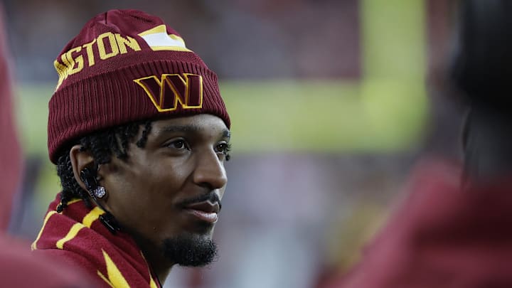 Oct 20, 2024; Landover, Maryland, USA; Injured Washington Commanders quarterback Jayden Daniels  looks on from the sidelines against the Carolina Panthers during the third quarter at Northwest Stadium. Mandatory Credit: Geoff Burke-Imagn Images