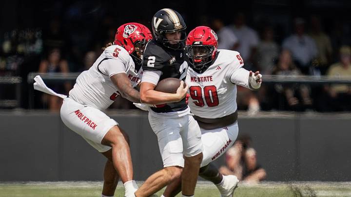 Vanderbilt quarterback Jared Curtis (2) is stopped by NC State linebacker Harvey Dyson III (5) and defensive lineman Josiah Victor (90) during the second quarter at FirstBank Stadium in Nashville, Tenn., Saturday, Sept. 19, 2026.