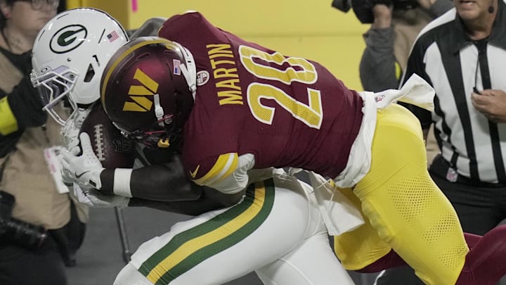 Green Bay Packers wide receiver Jayden Reed (11) is injured while being tackled by Washington Commanders safety Quan Martin.