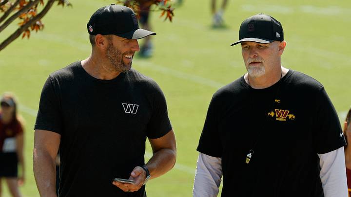 Jul 24, 2025; Ashburn, VA, USA; Washington Commanders general manager Adam Peters (L) talks with Commanders head coach Dan Quinn (R) while walking off the practice field on day two of training camp at OrthoVirginia Training Center at Commanders Park. Mandatory Credit: Geoff Burke-Imagn Images Jul 24, 2025; Ashburn, VA, USA; Washington Commanders general manager Adam Peters (L) talks with Commanders head coach Dan Quinn (R) while walking off the practice field on day two of training camp at OrthoVirginia Training Center at Commanders Park. Mandatory Credit: Geoff Burke-Imagn Images