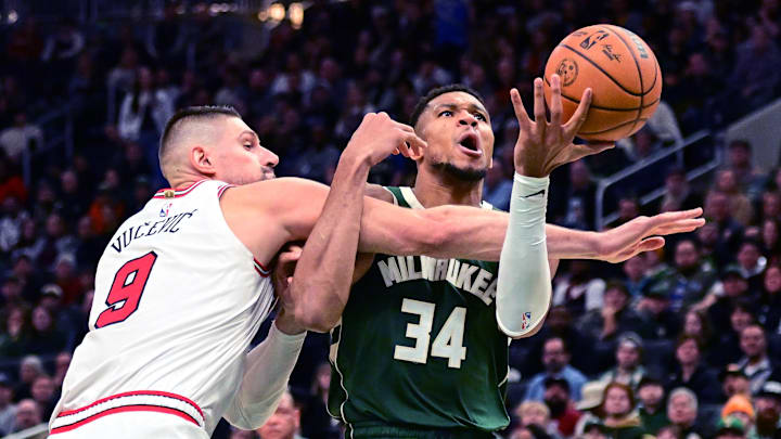Nov 20, 2024; Milwaukee, Wisconsin, USA;  Milwaukee Bucks forward Giannis Antetokounmpo (34) is fouled by Chicago Bulls center Nikola Vucevic (9) in the fourth quarter at Fiserv Forum. Mandatory Credit: Benny Sieu-Imagn Images
