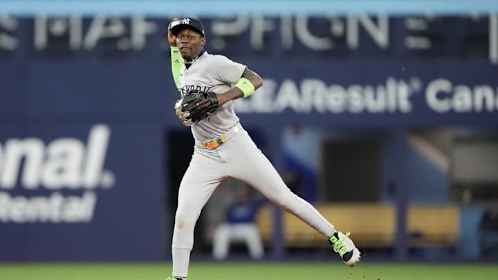 Oct 5, 2025; Toronto, Ontario, CAN; New York Yankees second baseman Jazz Chisholm Jr. (13) throws to first in the seventh inning against the Toronto Blue Jays during game two of the ALDS round for the 2025 MLB playoffs at Rogers Centre. Mandatory Credit: John E. Sokolowski-Imagn Images