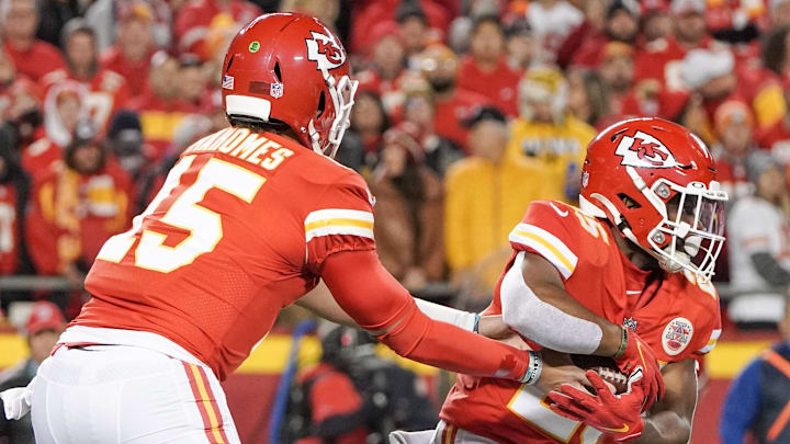 Dec 5, 2021; Kansas City, Missouri, USA; Kansas City Chiefs quarterback Patrick Mahomes (15) hands off to running back Clyde Edwards-Helaire (25) against the Denver Broncos during the first half at GEHA Field at Arrowhead Stadium. 