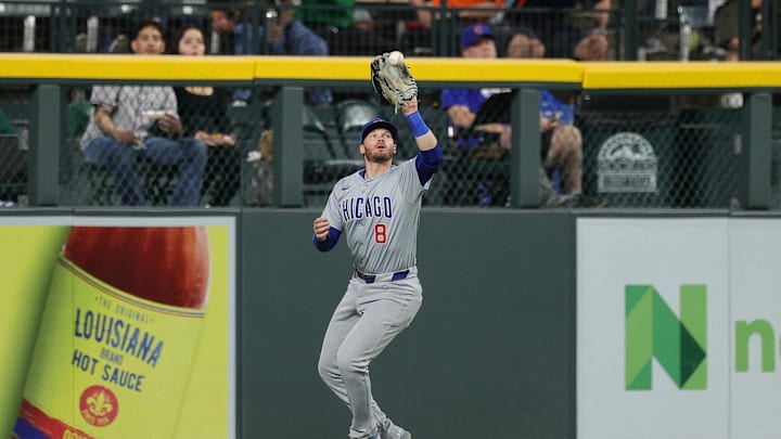 Sep 13, 2024; Denver, Colorado, USA; Chicago Cubs left fielder Ian Happ (8) makes a catch in the third inning against the Colorado Rockies at Coors Field. 