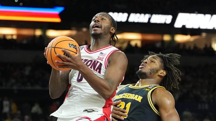 Apr 4, 2026; Indianapolis, IN, USA; Arizona Wildcats guard Jaden Bradley (0) shoots against Michigan Wolverines forward Morez Johnson Jr. (21) in the second half during a semifinal of the Final Four of the men's 2026 NCAA Tournament at Lucas Oil Stadium. Mandatory Credit: Robert Deutsch-Imagn Images Apr 4, 2026; Indianapolis, IN, USA; Arizona Wildcats guard Jaden Bradley (0) shoots against Michigan Wolverines forward Morez Johnson Jr. (21) in the second half during a semifinal of the Final Four of the men's 2026 NCAA Tournament at Lucas Oil Stadium. Mandatory Credit: Robert Deutsch-Imagn Images