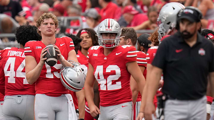 Aug 31, 2024; Columbus, OH, USA; Ohio State Buckeyes punter Nick McLarty (19) and punter Joe McGuire (42) stand on the sideline behind head coach Ryan Day during the NCAA football game at Ohio Stadium. Ohio State won 52-6.