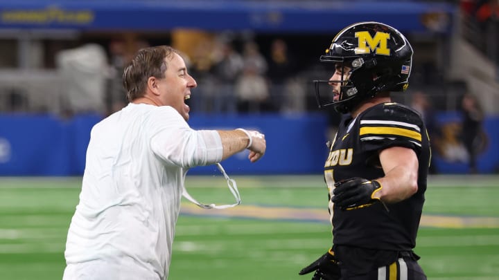 Dec 29, 2023; Arlington, TX, USA; Missouri Tigers head coach Eliah Drinkwitz congratulates running back Cody Schrader (7) after the game against the Ohio State Buckeyes at AT&T Stadium. Dec 29, 2023; Arlington, TX, USA; Missouri Tigers head coach Eliah Drinkwitz congratulates running back Cody Schrader (7) after the game against the Ohio State Buckeyes at AT&T Stadium.