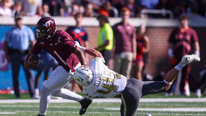 Oct 11, 2025; Atlanta, Georgia, USA; Virginia Tech Hokies quarterback Kyron Drones (1) is tackled by Georgia Tech Yellow Jackets linebacker Kyle Efford (44) in the first quarter at Bobby Dodd Stadium at Hyundai Field. Mandatory Credit: Brett Davis-Imagn Images
