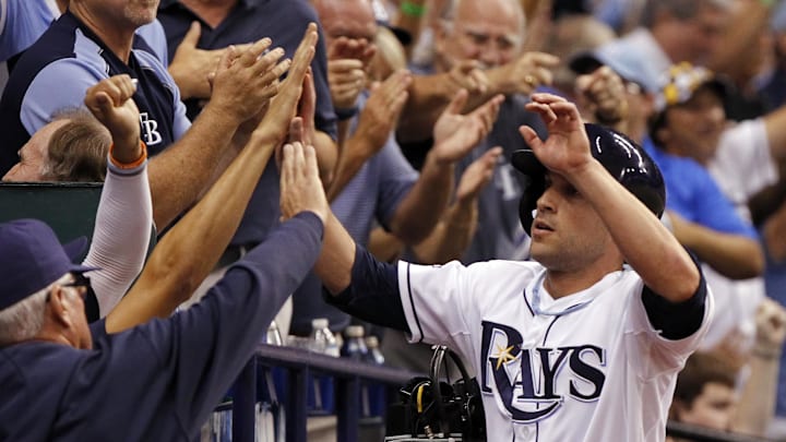 Tampa Bay Rays left fielder Sam Fuld (5) is congratulated by teammates after he scored a run during the eighth inning against the Boston Red Sox in game three of the American League divisional series at Tropicana Field. The Rays won 5-4 in 2013.