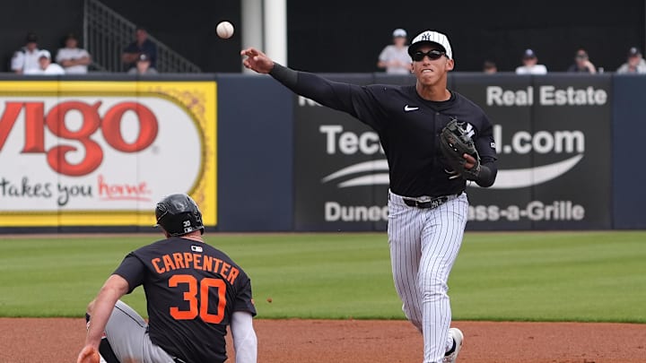 Mar 10, 2025; Tampa, Florida, USA; New York Yankees shortstop George Lombard Jr. (96) throws to first to make the double play as Detroit Tigers outfielder Kerry Carpenter (30) slides into second during the first inning at George M. Steinbrenner Field. Mandatory Credit: Dave Nelson-Imagn Images