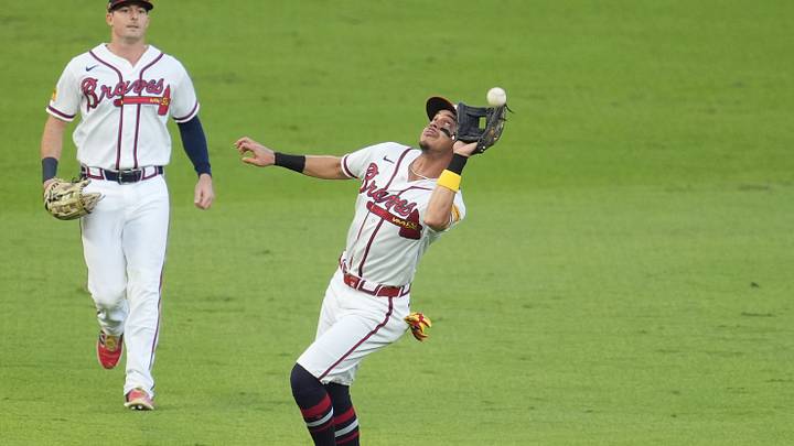 Cumberland, Georgia, USA;  Atlanta Braves outfielder Mauricio Dubon (14) makes an error on a hit by Los Angeles Dodgers third baseman Max Muncy (not pictured) during the second inning in game four of the NLDS for the 2026 MLB Playoffs at Truist Park.  Mandatory Credit: Dale Zanine-Imagn Images