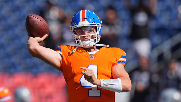 Denver Broncos quarterback Zach Wilson (4) warms up before the game against the Las Vegas Raiders at Empower Field at Mile High. Ron Chenoy-Imagn Images
